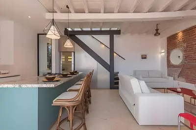 a kitchen and living room with a couch and a table at El Mirador de la Catedral - Centro Histórico in Cartagena de Indias