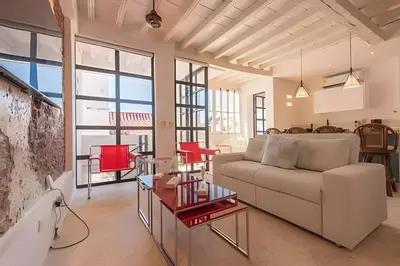 a living room with a couch and a table at El Mirador de la Catedral - Centro Histórico in Cartagena de Indias