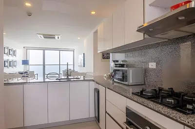 a kitchen with white cabinets and a stove top oven at Espectacular Apto de 2 Hab Piso 24 - Morros City in Cartagena de Indias