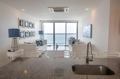a kitchen with a sink and a living room at Espectacular Apto de 2 Hab Piso 24 - Morros City in Cartagena de Indias