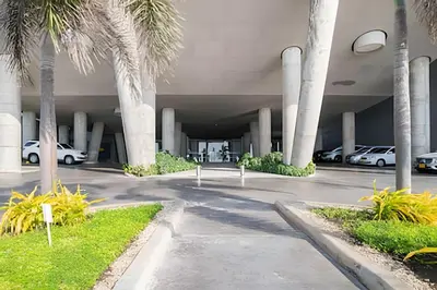 a parking lot with palm trees and parked cars at Lujoso Apto de 1 Habitación en Piso 40-Morros City in Cartagena de Indias