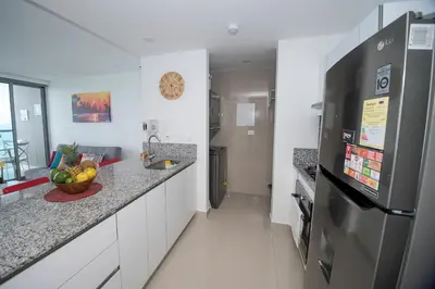 a kitchen with a counter with a sink and a refrigerator at Espectacular Apto 1 Hab en Bocagrande - 2504 in Cartagena de Indias