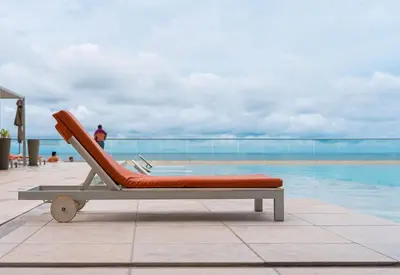 a lounge chair sitting next to a swimming pool at Espectacular Apto 1 Hab en Bocagrande - 2504 in Cartagena de Indias
