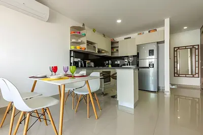 a kitchen and dining room with a table and chairs at Infinitum - Spectacular sea view 25th floor apt in Cartagena de Indias