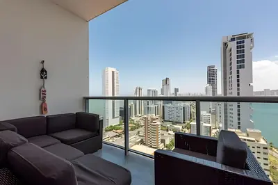 a living room with a couch and a view of the city at Infinitum - Spectacular sea view 25th floor apt in Cartagena de Indias