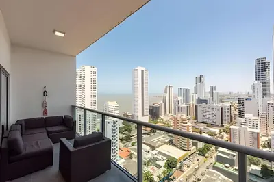 a living room with a view of a city at Infinitum - Spectacular sea view 25th floor apt in Cartagena de Indias
