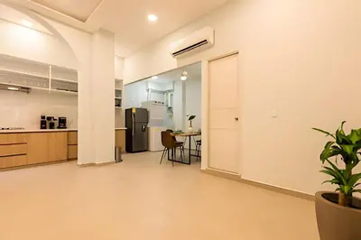 a kitchen and dining room with a table and a refrigerator at Apto con balcón en en Centro Historico - Zaher G in Cartagena de Indias