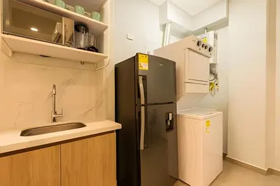 a small kitchen with a refrigerator and a sink at Apto con balcón en en Centro Historico - Zaher G in Cartagena de Indias