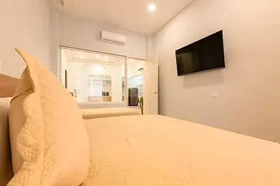 a bedroom with a bed with a television on the wall at Apto con balcón en en Centro Historico - Zaher G in Cartagena de Indias