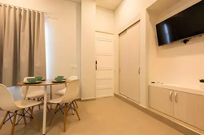 a dining room with a table and chairs and a television at Espectacular apto en Centro Histórico - Zaher F in Cartagena de Indias