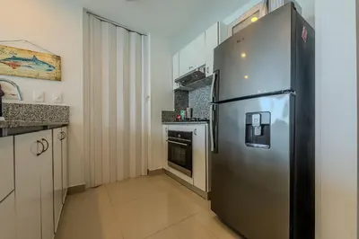 a kitchen with a large stainless steel refrigerator at Piso 27 - Espectacular apartamento en Bocagrande in Cartagena de Indias