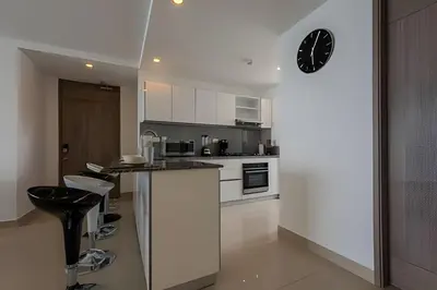 a kitchen with a counter and a clock on the wall at 3605 Morros City - Paraiso en Cartagena in Cartagena de Indias
