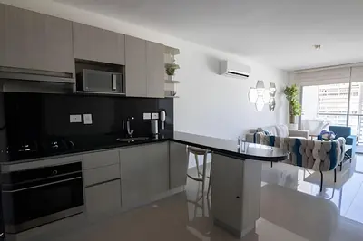 a kitchen with a black counter top in a room at Infinitum Espectacular apto piso 28 vista al mar in Cartagena de Indias