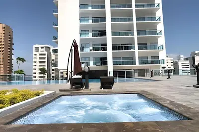 a swimming pool in front of a building at Infinitum Espectacular apto piso 28 vista al mar in Cartagena de Indias