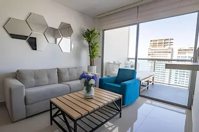 a living room with a couch and a table at Infinitum Espectacular apto piso 28 vista al mar in Cartagena de Indias
