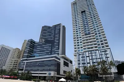 two tall buildings in a city with palm trees at Lujoso Apto Vista al Mar Piso 34 - Palmetto Beach in Cartagena de Indias