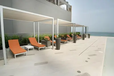 a row of orange chairs and tables on a building at Morros City - Lujoso Apto con vista al mar Piso 28 in Cartagena de Indias