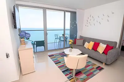 a living room with a couch and a table at Morros City - Lujoso Apto con vista al mar Piso 28 in Cartagena de Indias