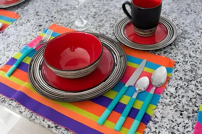 a table with two plates and a cup and spoons at Lujoso Apto de 1 habitacion en piso 29-Morros City in Cartagena de Indias