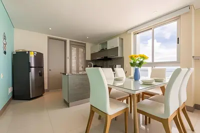 a kitchen and dining room with a table and chairs at Espectacular apt en el piso 29 en Palmetto Beach in Cartagena de Indias