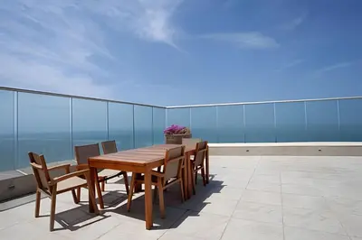 a wooden table and chairs on a balcony at Lujoso Apto de 3 Habitaciones-3303 Palmetto Beach in Cartagena de Indias