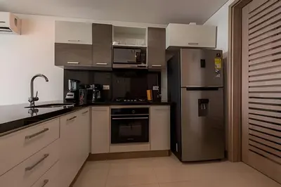 a kitchen with stainless steel appliances and white cabinets at Palmetto Sunset piso 33 - Vista espectacular in Cartagena de Indias