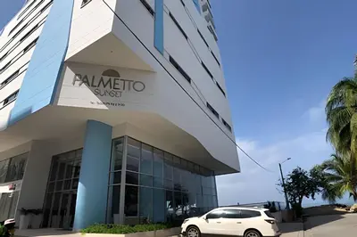 a white car parked in front of a building at Palmetto Sunset piso 33 - Vista espectacular in Cartagena de Indias