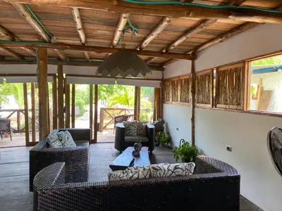 a living room with two couches and a table at Pirita Beach House in Santa Ana