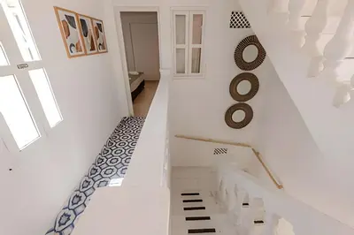 a white staircase with a black and white floor at Casa Hibiscus - Joya en Getsemani in Cartagena de Indias