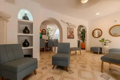 a waiting room with chairs and a table at Casa Hibiscus - Joya en Getsemani in Cartagena de Indias