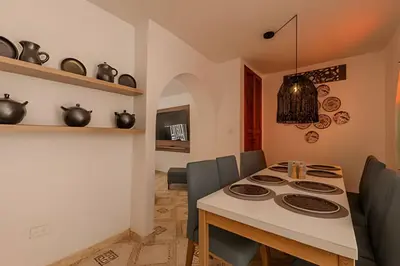 a kitchen and dining room with a table and chairs at Casa Hibiscus - Joya en Getsemani in Cartagena de Indias