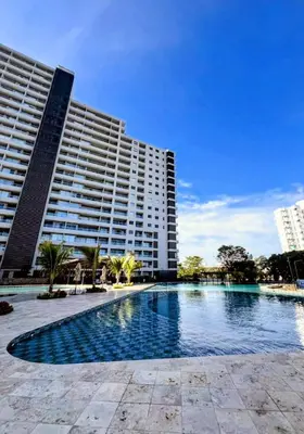 a swimming pool in front of a large building at Apartamento con vista al mar in Simón Bolivar