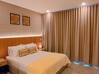 a bedroom with a bed and a window with curtains at Apartamento con vista al mar in Simón Bolivar