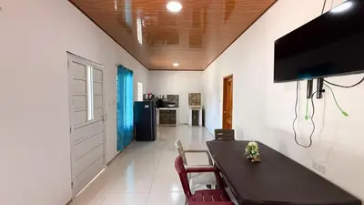 a dining room with a black table and chairs at Cabaña Datalu 3 in Coveñas