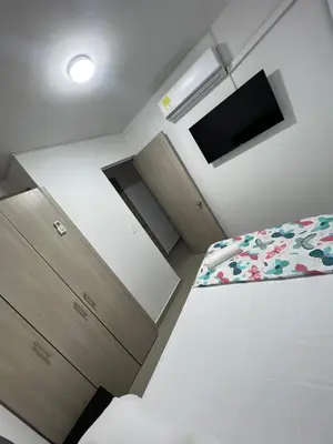 a small bedroom with a bed and a tv at Rent by days, 4th floor apartment in Cartagena de Indias