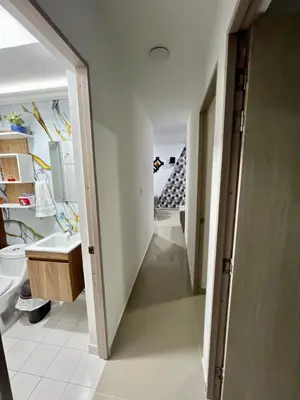 a hallway leading to a bathroom with a sink at Rent by days, 4th floor apartment in Cartagena de Indias