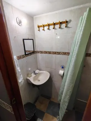 a small bathroom with a sink and a shower at Habitación Privada con Ventilador in Cartagena de Indias