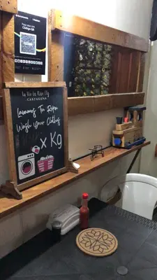 a kitchen with a counter with a chalkboard on it at Habitación Privada con Ventilador in Cartagena de Indias