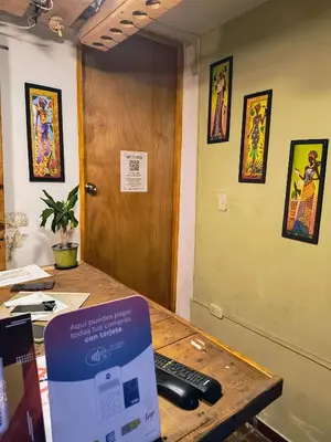 an office with a desk with a remote control on it at Habitación Privada con Ventilador in Cartagena de Indias