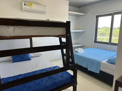 a bedroom with two bunk beds and a window at Hotel mirador Dubai in San Antero