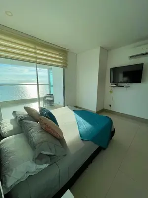 a bedroom with a bed with a view of the ocean at Apartamento en Cartagena cerca al Hotel Hilton in Cartagena de Indias