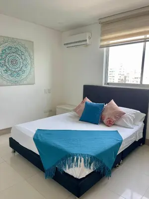 a bedroom with a large bed with pillows on it at Apartamento en Cartagena cerca al Hotel Hilton in Cartagena de Indias