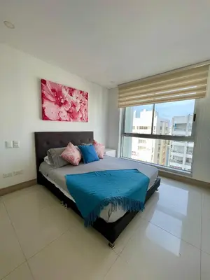 a bedroom with a bed and a large window at Apartamento en Cartagena cerca al Hotel Hilton in Cartagena de Indias