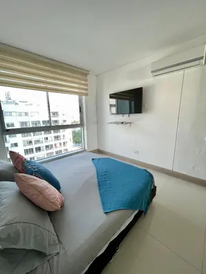 a bedroom with a large bed with a large window at Apartamento en Cartagena cerca al Hotel Hilton in Cartagena de Indias