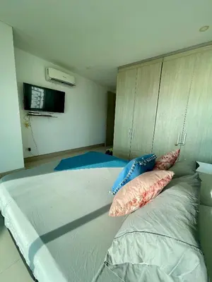 a bedroom with a large bed with pillows on it at Apartamento en Cartagena cerca al Hotel Hilton in Cartagena de Indias