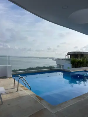 a large swimming pool with a view of the water at Oceani Towers 1006 in Cartagena de Indias