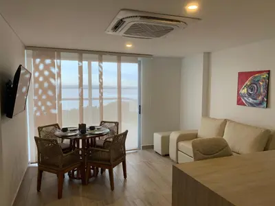 a living room with a table and chairs and a couch at Oceani Towers 1006 in Cartagena de Indias
