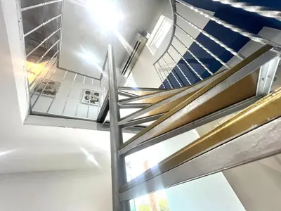 a spiral staircase in a building with a window at Apartaestudio Cielo Mar A 100 Mts playa - Al Frente Hotel Las Americas in Cartagena de Indias