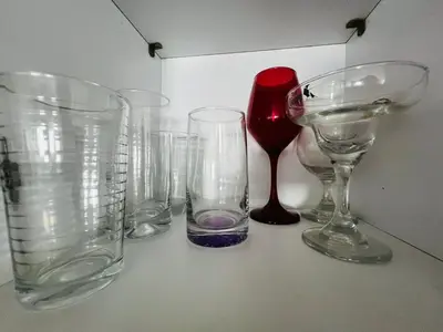 a group of empty glasses sitting on a table at Apartaestudio Cielo Mar A 100 Mts playa - Al Frente Hotel Las Americas in Cartagena de Indias