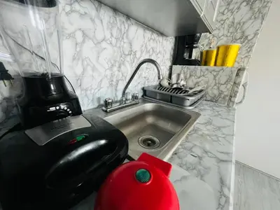 a kitchen with a mixer next to a sink at Apartaestudio Cielo Mar A 100 Mts playa - Al Frente Hotel Las Americas in Cartagena de Indias